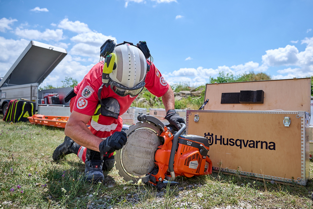 Einsatzkraft der Samariterbund Katastrophenhilfe präsentiert Kettensäge von Husqvarna